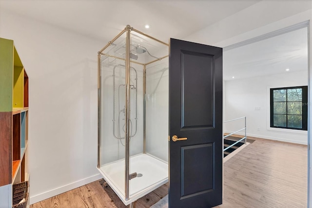 bathroom featuring hardwood / wood-style flooring and an enclosed shower