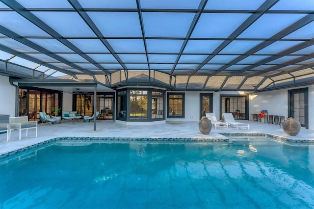 view of pool with a lanai, a patio, and ceiling fan