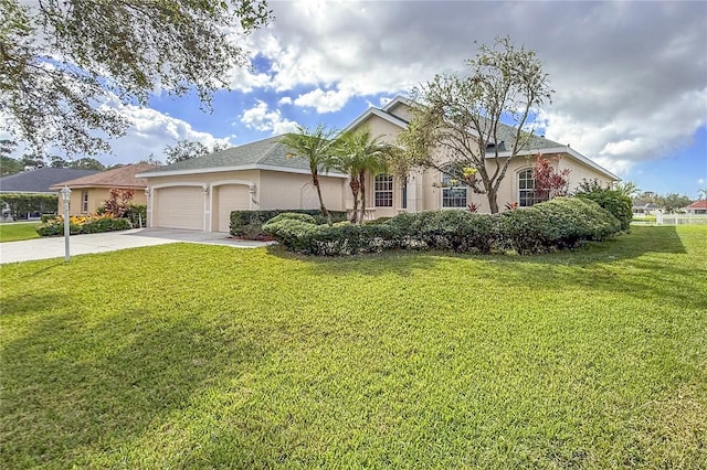 view of front of home featuring a front lawn, an attached garage, driveway, and stucco siding