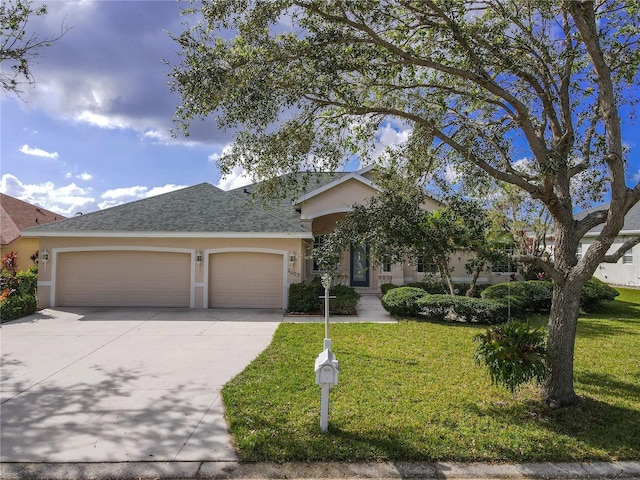 view of front of property with a garage and a front lawn