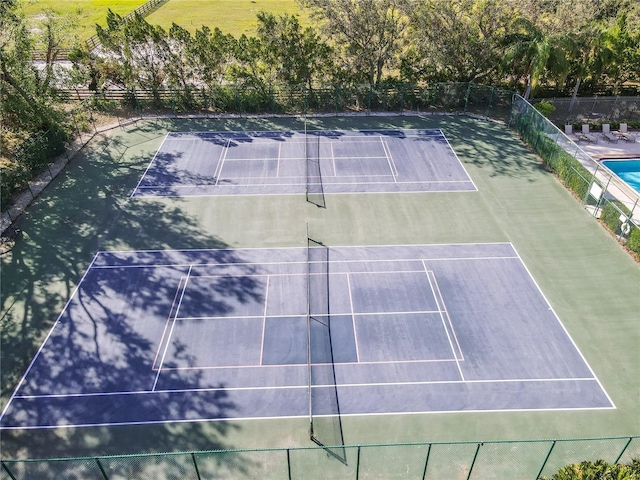 view of sport court featuring fence