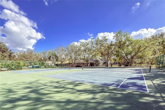 view of tennis court with fence