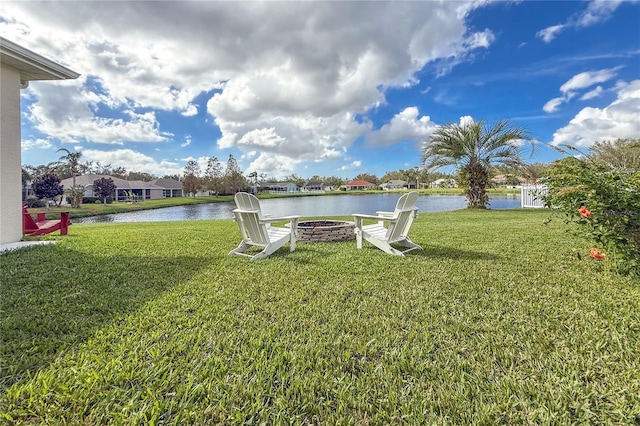 view of yard with a fire pit and a water view