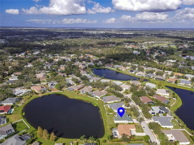 drone / aerial view with a residential view and a water view