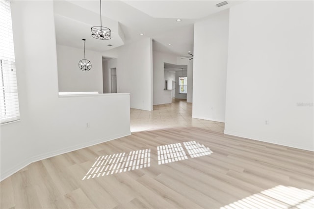 unfurnished room featuring visible vents, baseboards, a chandelier, and light wood finished floors