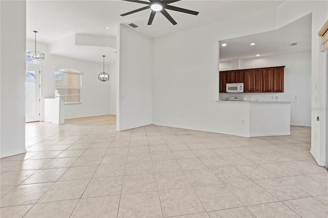 unfurnished living room featuring visible vents, ceiling fan with notable chandelier, recessed lighting, light tile patterned flooring, and baseboards