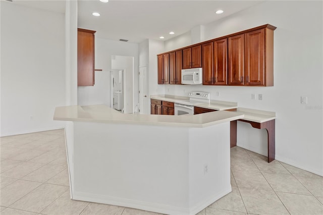 kitchen with recessed lighting, white appliances, a peninsula, and light countertops