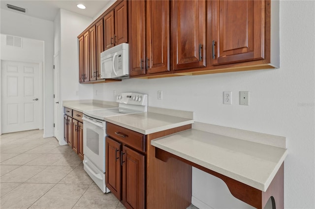 kitchen with light tile patterned floors, visible vents, white appliances, and light countertops