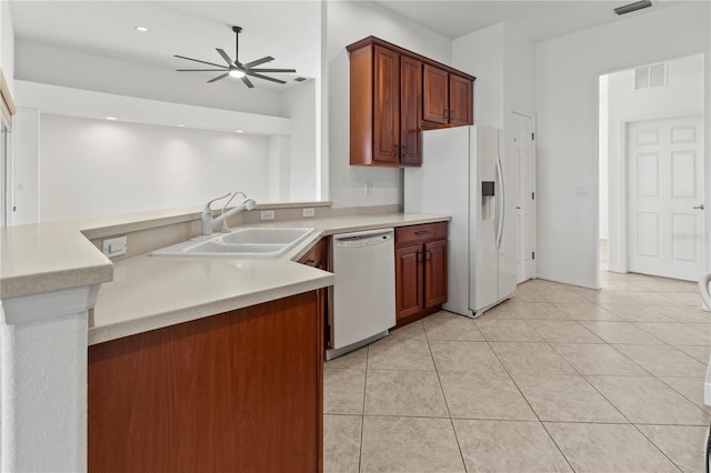 kitchen featuring visible vents, a ceiling fan, a sink, white appliances, and light tile patterned floors