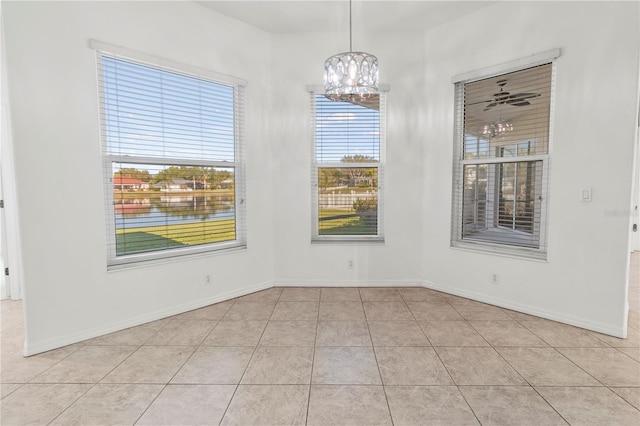 unfurnished dining area featuring light tile patterned flooring, baseboards, and a chandelier