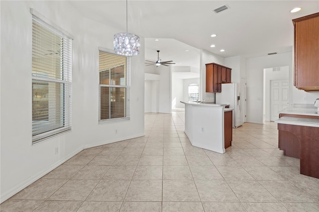 kitchen with visible vents, light countertops, light tile patterned floors, recessed lighting, and white refrigerator with ice dispenser