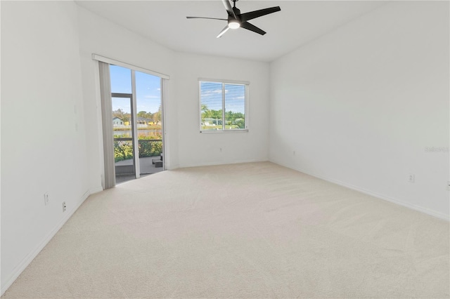 unfurnished room with light carpet, baseboards, and ceiling fan