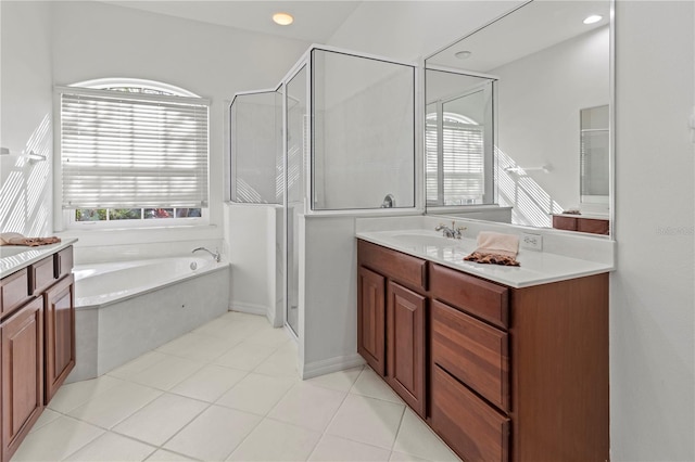 full bathroom featuring vanity, a garden tub, a stall shower, and tile patterned floors