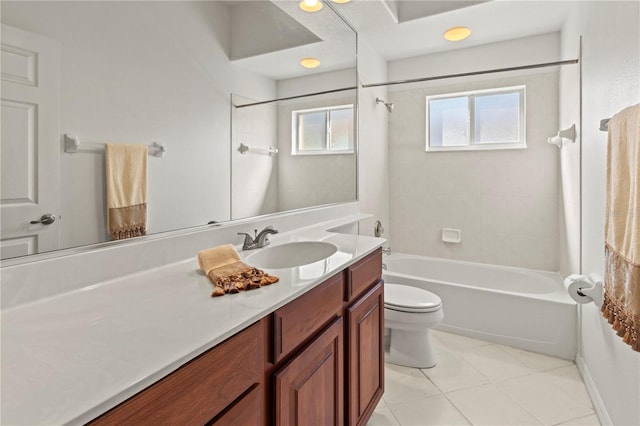 bathroom featuring tile patterned floors, toilet, vanity, and shower / tub combination