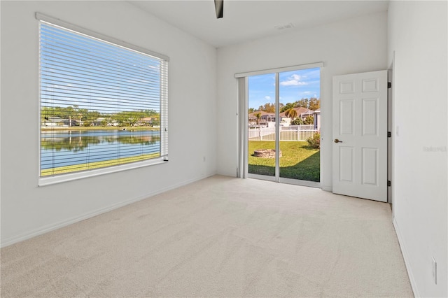 empty room featuring carpet flooring and baseboards