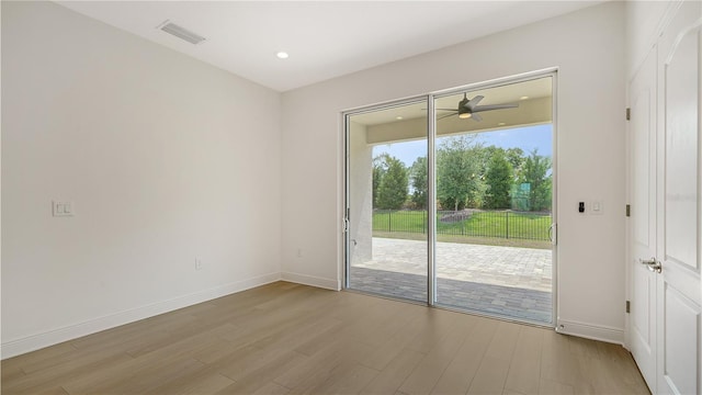 doorway featuring ceiling fan and light hardwood / wood-style floors