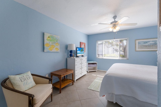 tiled bedroom featuring ceiling fan