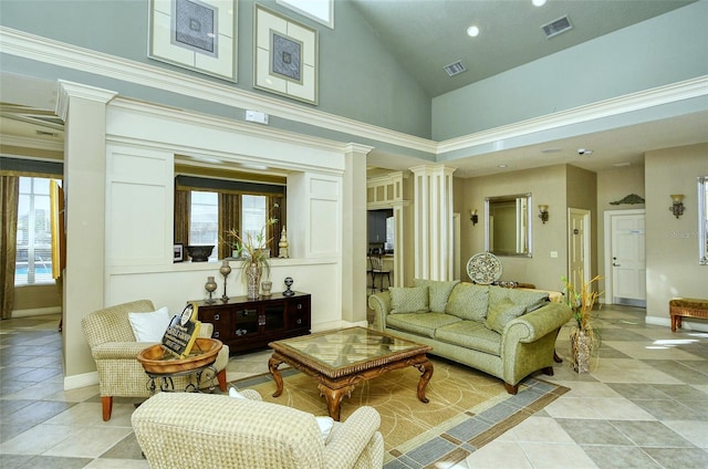 interior space with a wealth of natural light, light tile patterned flooring, ornate columns, and high vaulted ceiling