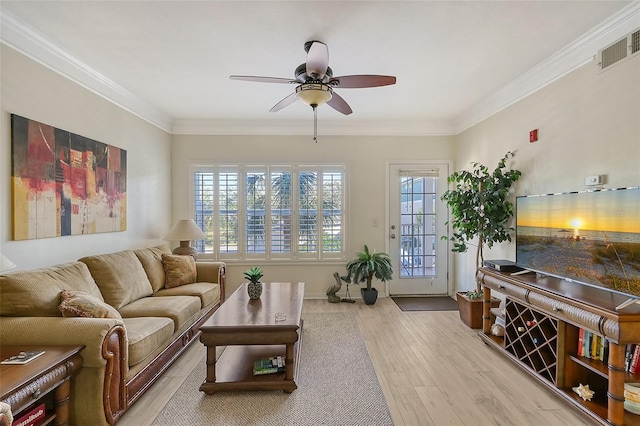 living room featuring ceiling fan, a healthy amount of sunlight, crown molding, and light hardwood / wood-style flooring