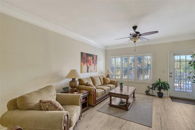 living room with light hardwood / wood-style floors, ceiling fan, and crown molding