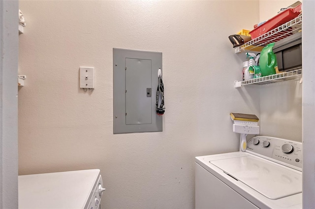 clothes washing area with separate washer and dryer and electric panel