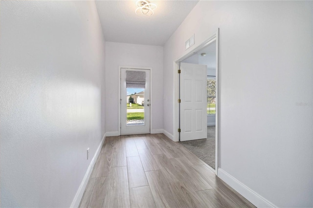 doorway to outside with light hardwood / wood-style flooring