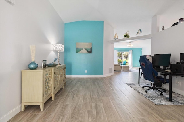 office area featuring vaulted ceiling and light hardwood / wood-style flooring