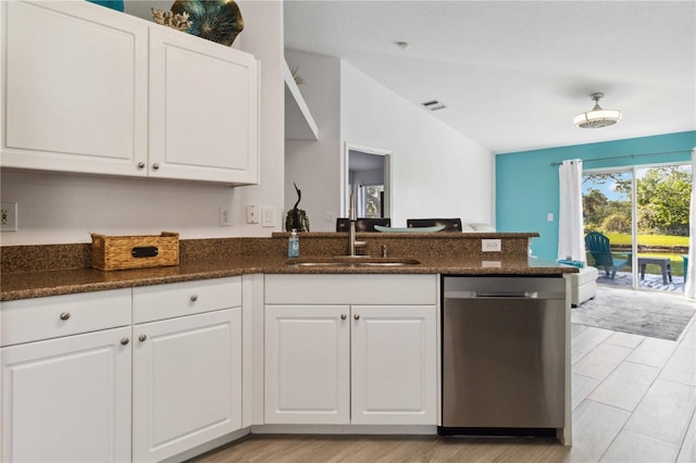 kitchen featuring dishwasher, vaulted ceiling, white cabinetry, and sink