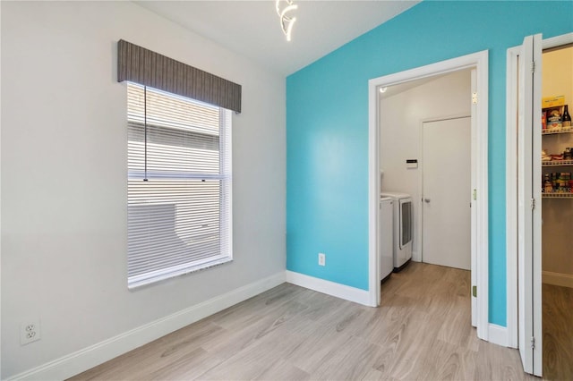 interior space featuring separate washer and dryer and light hardwood / wood-style floors