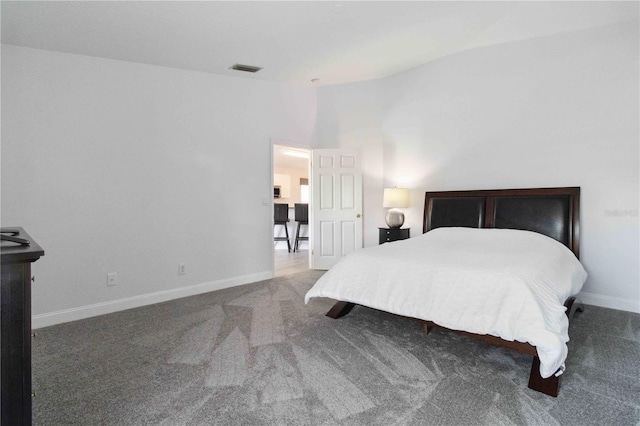 carpeted bedroom with vaulted ceiling