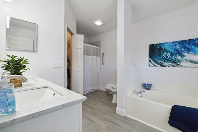 full bathroom with separate shower and tub, vanity, wood-type flooring, and toilet