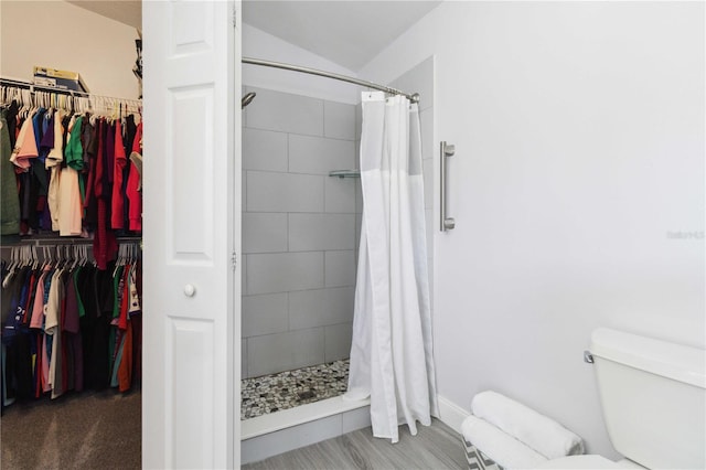 bathroom with a shower with curtain and toilet