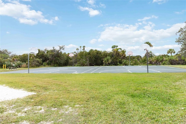 view of basketball court featuring a yard