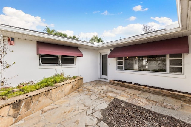 doorway to property with a patio