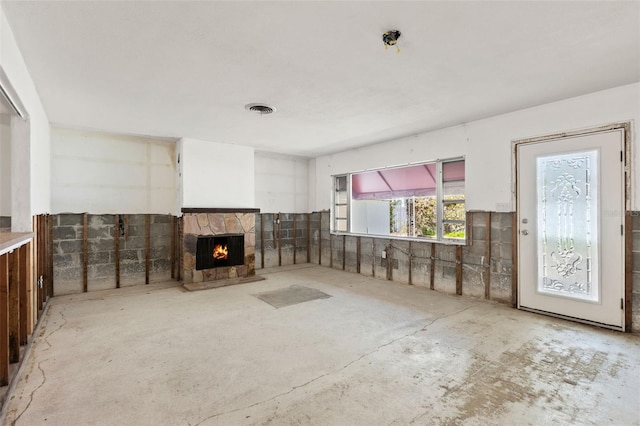 unfurnished living room featuring a fireplace