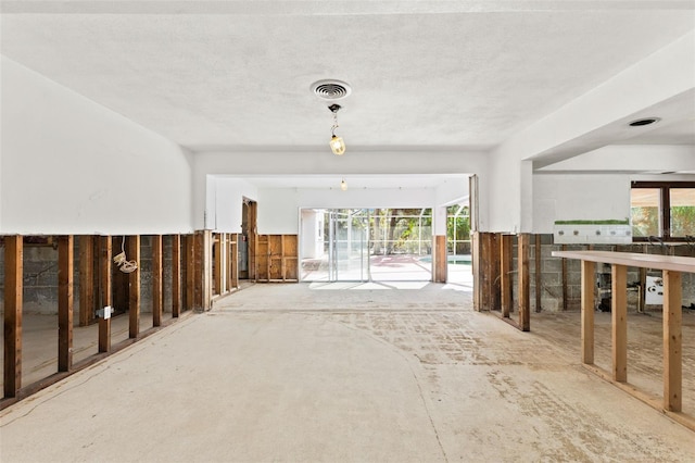 interior space featuring a textured ceiling and a wealth of natural light