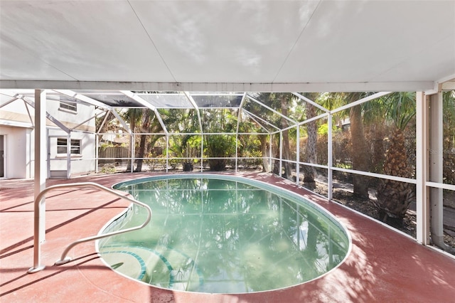 view of swimming pool featuring a lanai and a patio