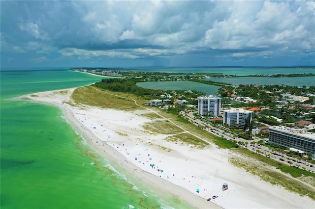 drone / aerial view with a beach view and a water view