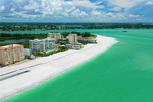 drone / aerial view with a water view and a beach view