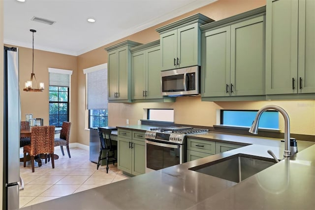 kitchen featuring sink, stainless steel appliances, and green cabinetry