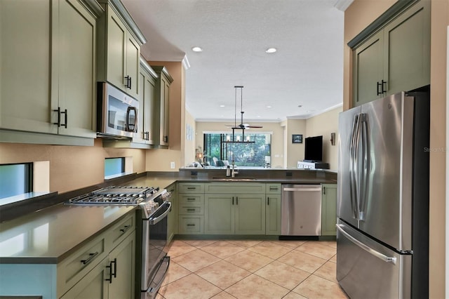 kitchen with ceiling fan, green cabinetry, and appliances with stainless steel finishes