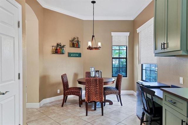 dining area with crown molding, light tile patterned floors, and an inviting chandelier