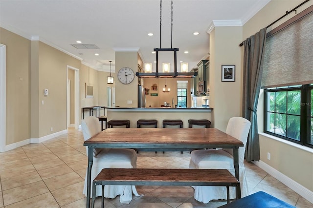 dining space featuring plenty of natural light, light tile patterned floors, and ornamental molding