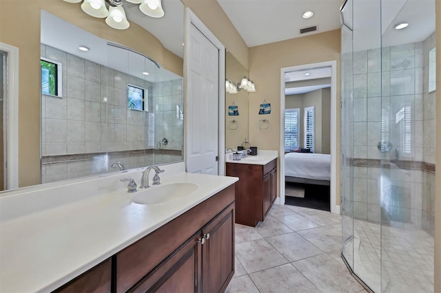 bathroom with tile patterned floors, vanity, and a shower with shower door