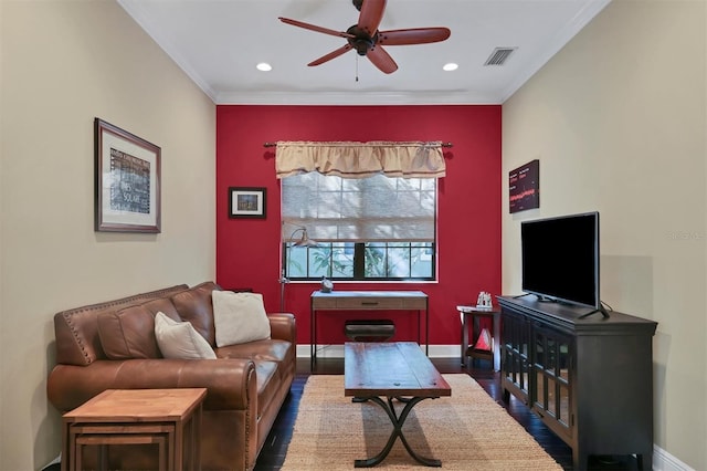 living room featuring dark hardwood / wood-style floors, ceiling fan, and crown molding