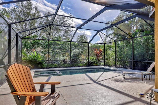 exterior space with glass enclosure and a swimming pool with hot tub