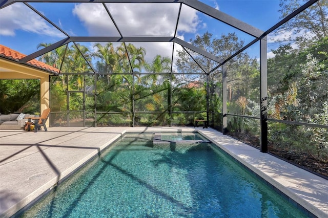 view of swimming pool with a lanai and a patio area