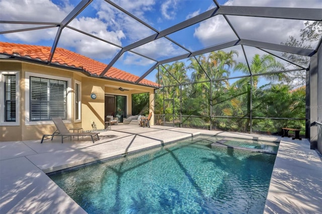 view of pool featuring a lanai, a patio area, and ceiling fan