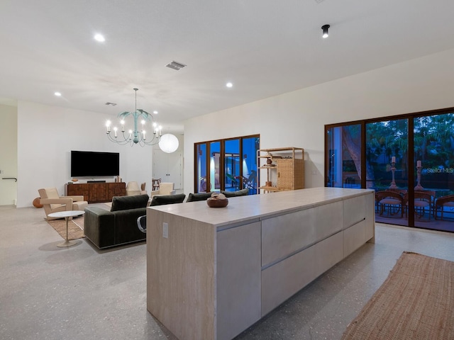 kitchen with a large island, decorative light fixtures, and an inviting chandelier