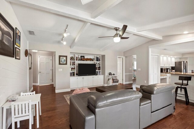 living room featuring lofted ceiling with beams, ceiling fan, and dark wood-type flooring